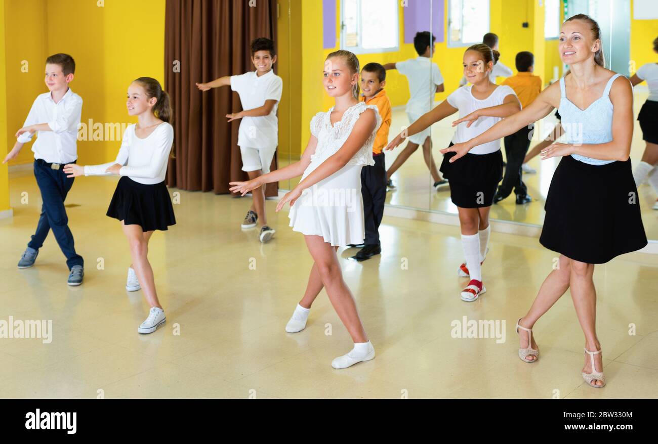 Friendly children learn dance movements in dance class Stock Photo - Alamy