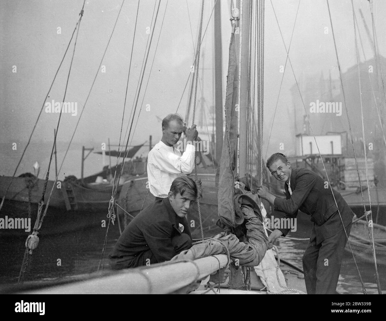 Young Estonians arrive in London after crossing Atlantic twice in tiny sloop . After a double journey across the Atlantic with her crew of three young Estonians , two brothers , J and Walter Ahto , aged 23 and 20 , and a friend , W Sooman , who is 21 , sailed up the Thames and moored near Billingsgate market after a 37 day voyage from New York . Left to right : J Ahto and Walter Ahto , who is captain , and W Sooman ( seated beneath ) aboard their boat at Billingsgate , London . 18 August 1932 Stock Photo