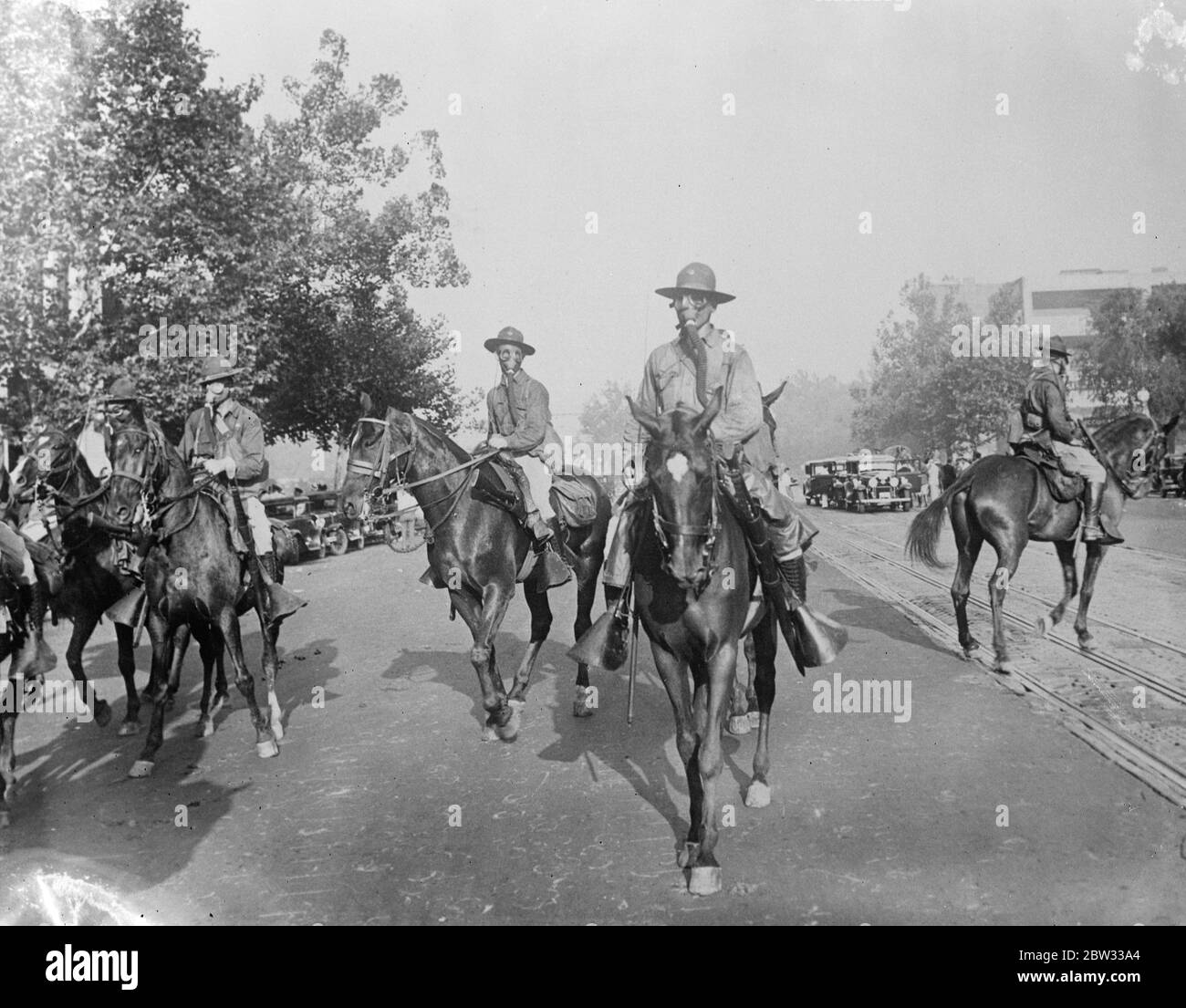 Bonus army camp burned to the ground and marches dispered in fierce fight at Washington . Federal troops completely routed eight thousand ' bonus army ' marchers encamped open parkland outside Washington , and burned their camp of wooden shacks to the ground . Cavalrymen in gas masks advancing down Pennsylvania Avenue , Washington during the fighting . 5 August 1932 Stock Photo