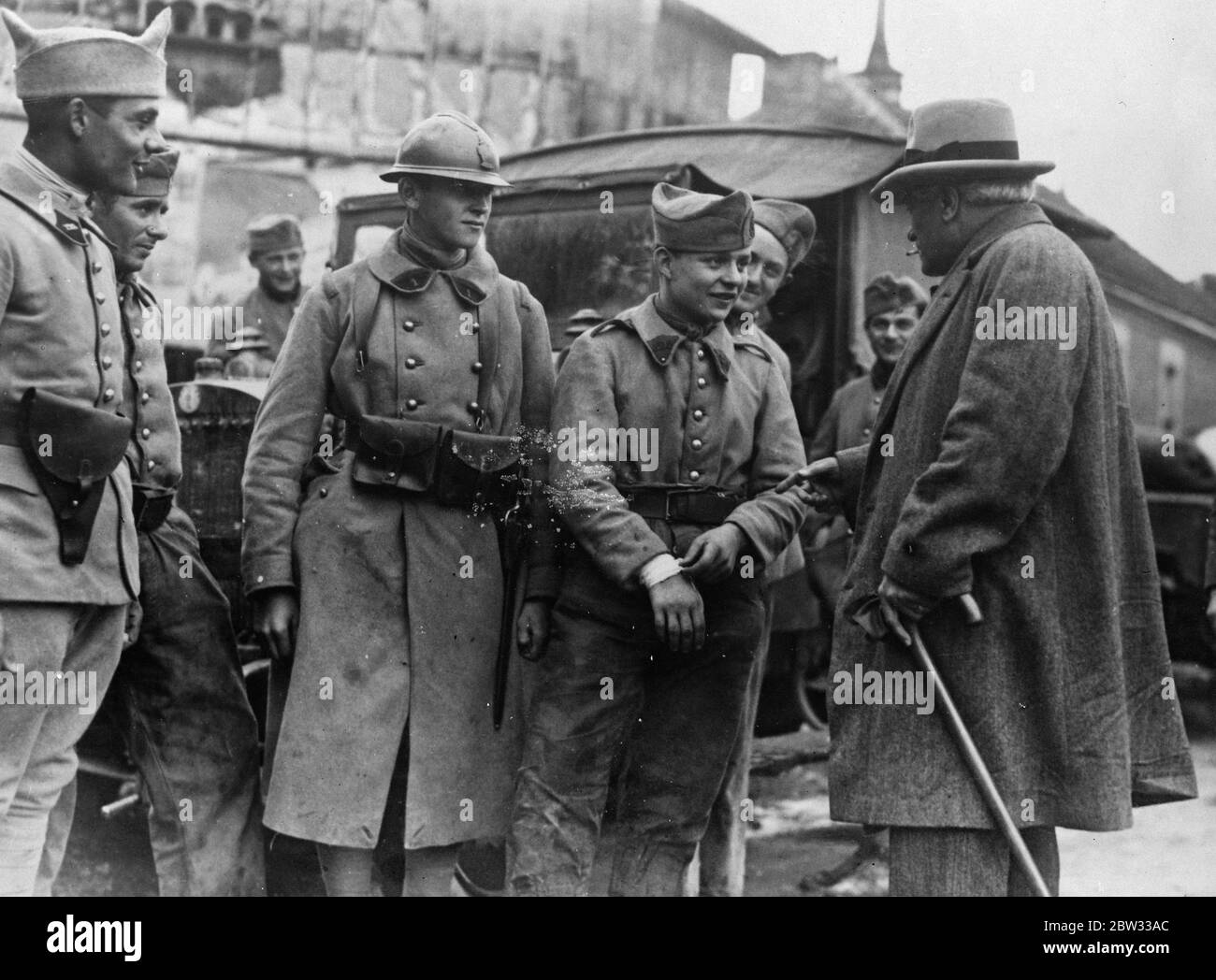 French War Minister meets recruits . French army manoeuvres on the Marne . The French army is engaged on its annual autumn manoeuvres on the Marne , when all the mechanised sections have been brought into operation . M Paul Boncour , French Minister of War , talking with young recruits in the  war area  near Chalons , France . 21 September 1932 Stock Photo