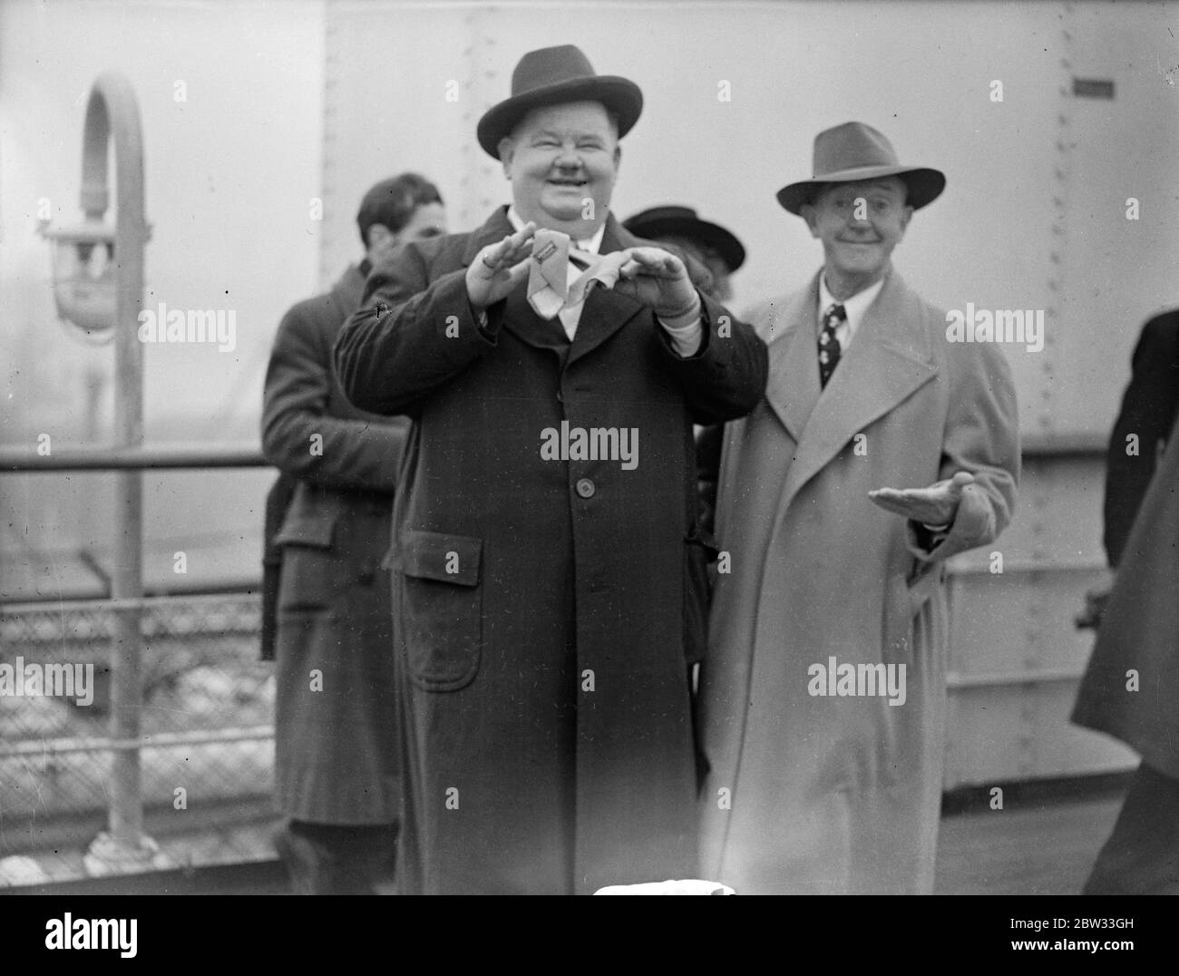 Laurel and Hardy arrive in Britain on the  Queen Elizabeth  . Oliver Hardy , the bulky Hollywood film comedian , and his glum looking partner , Stan Laurel , arrived at Southampton aboard the liner  Queen Elizabeth  . This is their first visit to Britain since 1932 . During their visit they will go on tour with a skit called  Getting a Driving License  . They open at Newcastle , go on to Birmingham , and then to the Palladium in London . It is two years since Laurel and Hardy made a film , they have been touring in Vaudeville and playing to troops . Stan Laurel ( on left ) and Oliver Hardy ( r Stock Photo