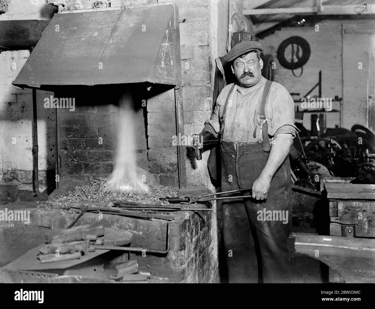 One armed blacksmith at the anvil . Although he has only one arm , Mr Paddy O ' Neil of Napier Road Ponders End , London is a very successful blacksmith . When his right forearm was crushed under a steam hammer , Mr O ' Neil invented a hammer head arrangement which he is able to fix on his artificial arm . Mr Paddy O ' Neil , at work at his forge at Ponders End . 6 October 1932 Stock Photo