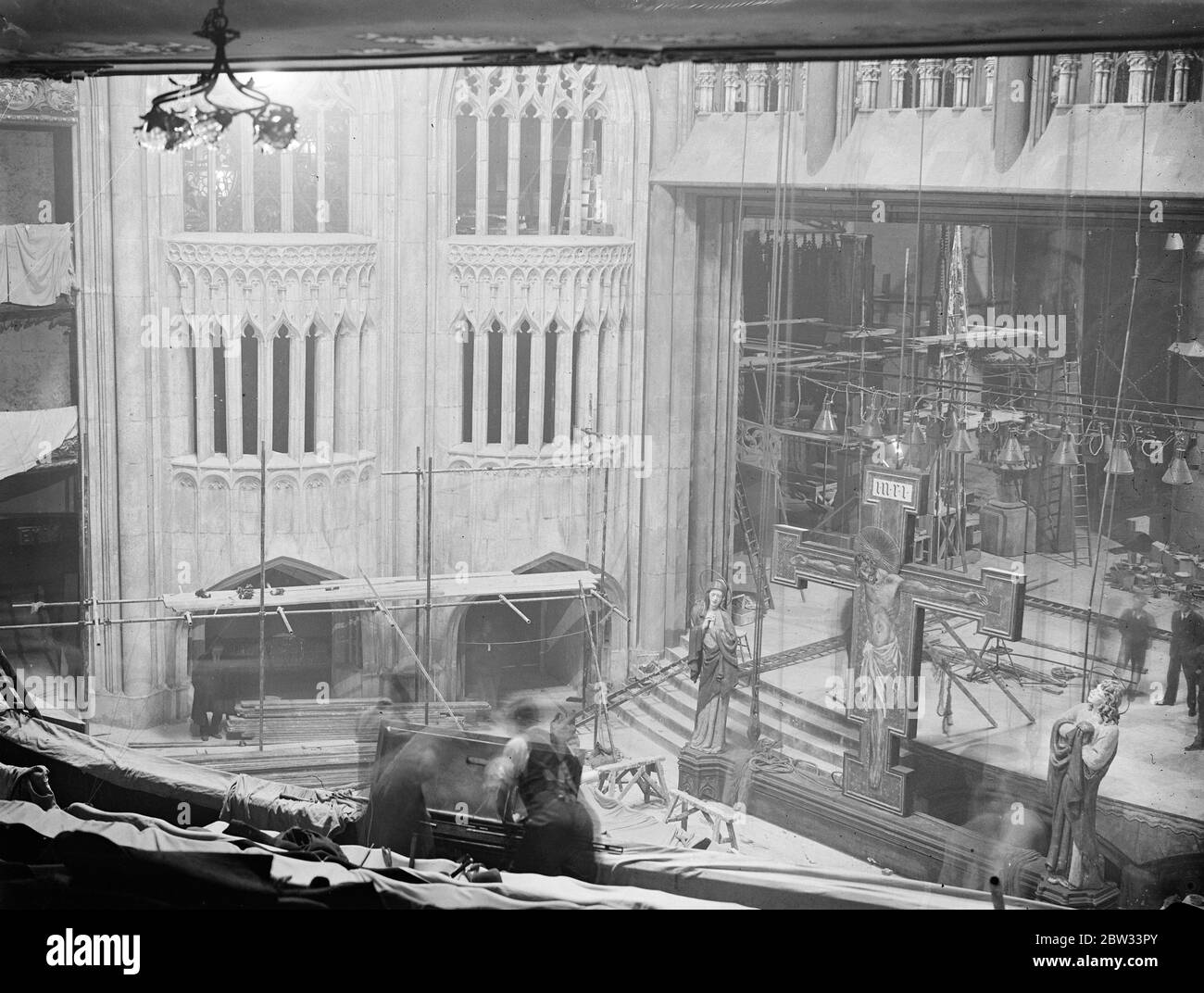 Theatre rebuilt like a cathedral . For the performance of the ' the miracle ' which is shortly to be produced at the Lyceum theatre . , the whole interior of the theatre and the stage is being transformed to represent the interior of a cathedral . The work of transforming the theatre to resemble a cathedral in progress inside the Lyceum Theatre , london . 19 March 1932 Stock Photo