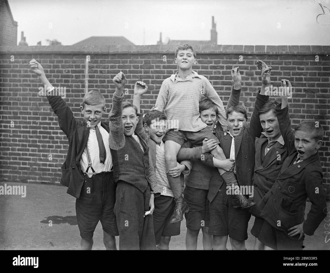 Brothers dive into Thames to rescue Roy . Two brothers , George Dallagan , aged 11 and Edward Dallagan , aged 14 , dived into the Thames from Globe Pier , Rotherhithe , London , to the rescue of a playmate , aged five , Victor Bowden , who was playing on the steps of the pier when he slipped and fell into the river . They were fully clothed but managed to rescue the boy . Cheering George Dallagan as he was chaired by schoolmates at Albany Road school , Rotherhithe , after the rescue . 19 September 1932 Stock Photo