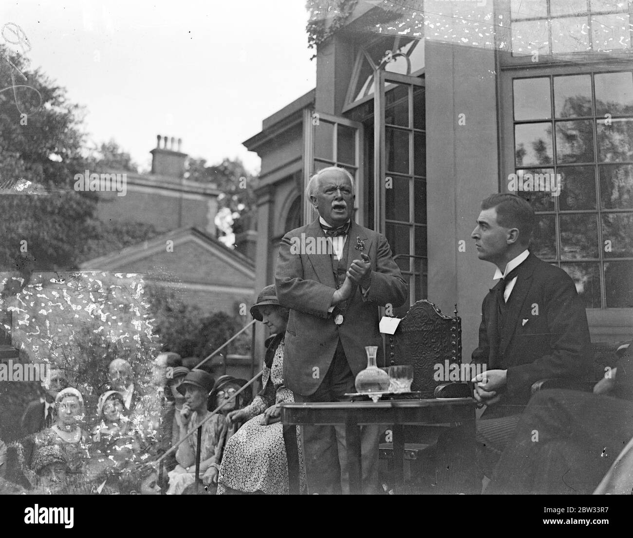 Lloyd George addresses Young Liberals at garden party in his London home . Mr Lloyd George addressed a large gathering of Young Liberals from the home counties at a garden party at his home at Addison Road , Kensington . Mr Lloyd George addressing the gathering at the party . 25 June 1932 Stock Photo
