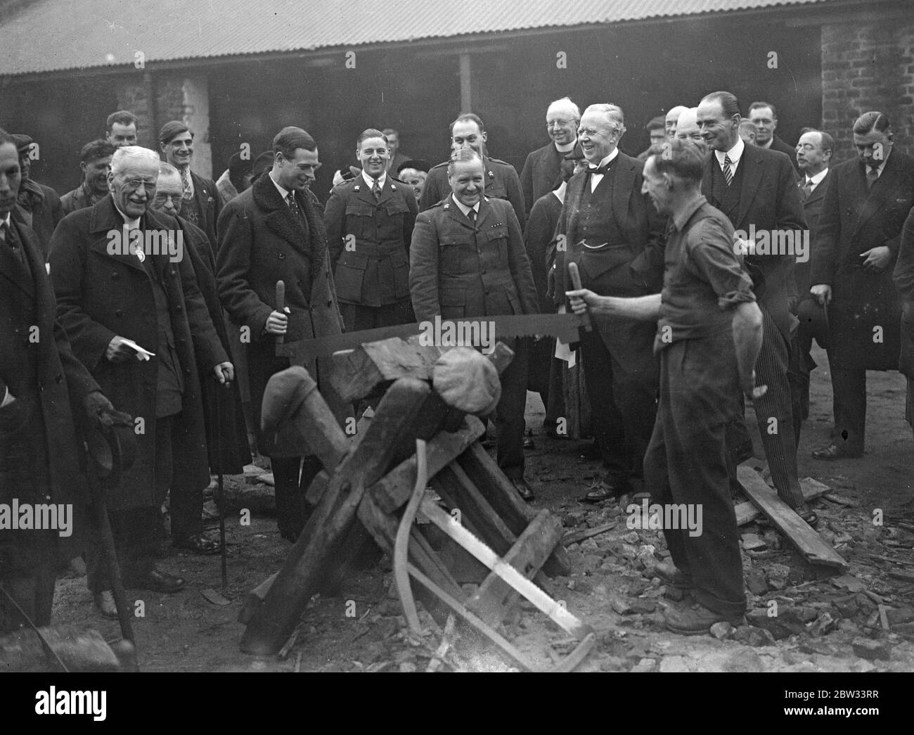 Prince George tries his hand at sawing wood . Prince George helping to saw wood when he visited the new Church army Labour Home in Acre Lane , Brixton , to open the extension of the building . 27 January 1932 Stock Photo