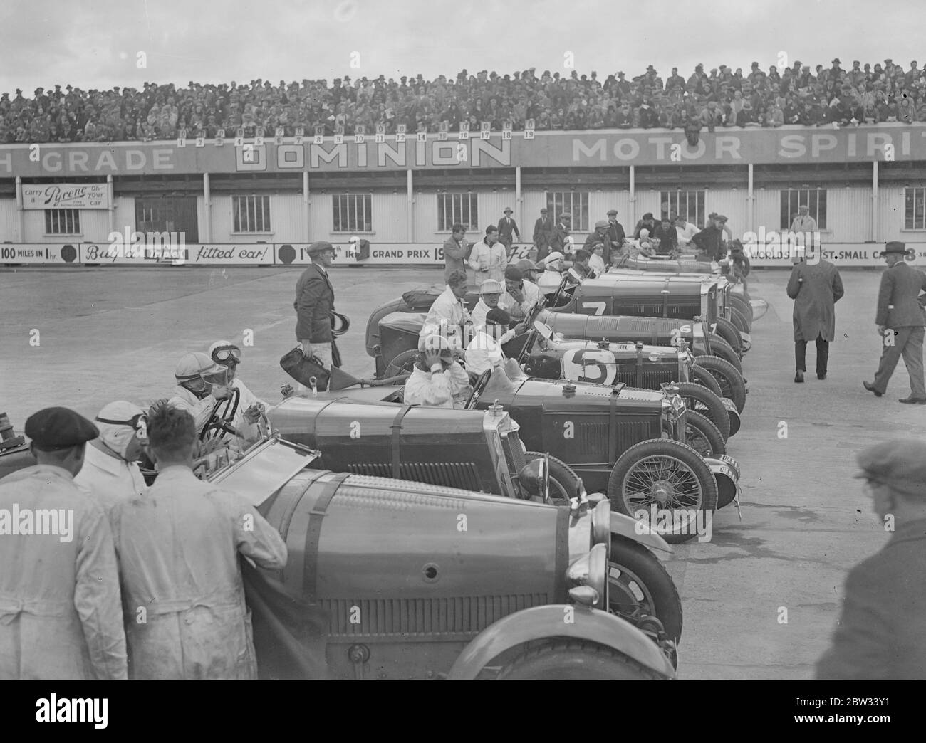A close race at Brooklands . Crowds thronged the Brookland track for