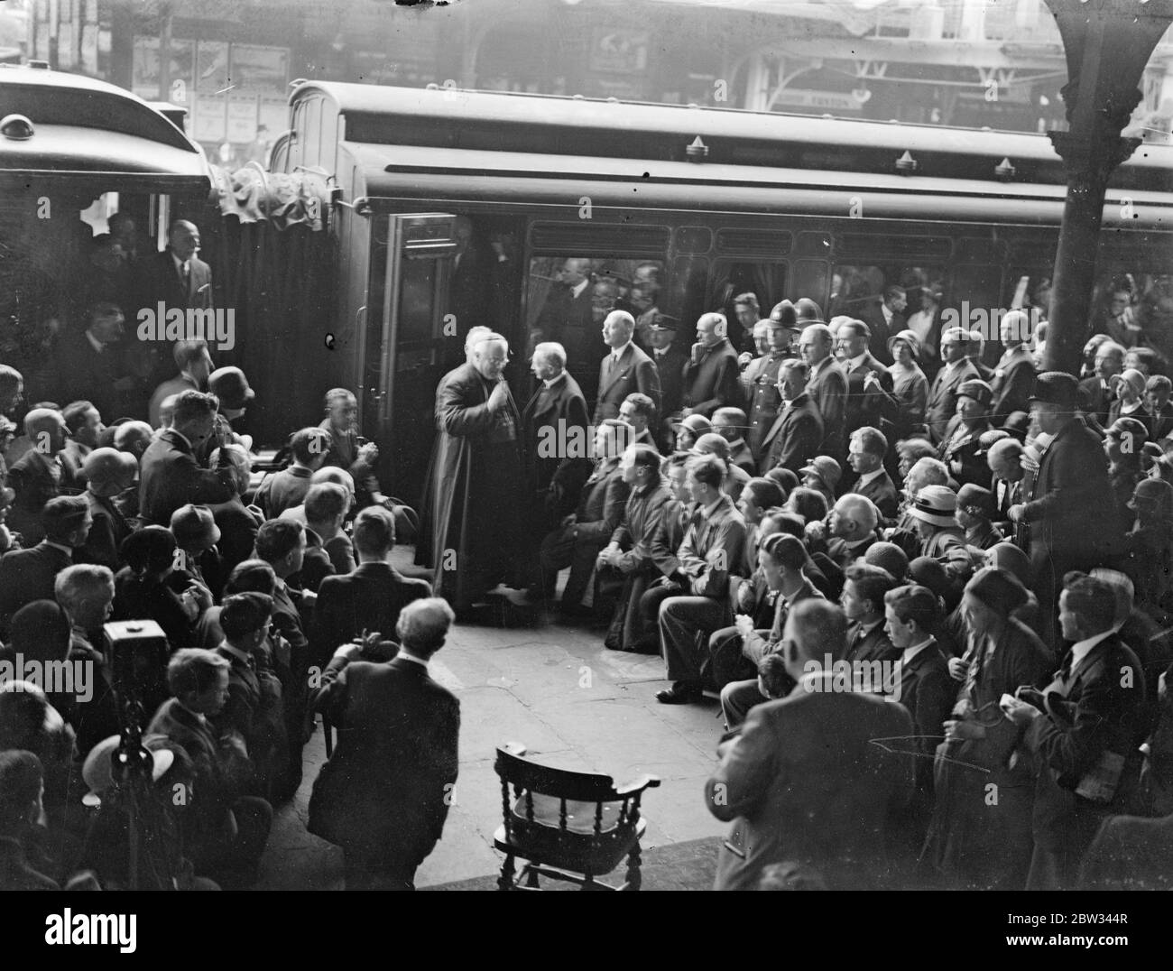 Papal Legate to eucharistic congress arrives in London on way to Dublin . Cardinal Lauri , the Papal Legate to the Eucharistic Congress in Dublin arrived in London at Addison Road station , on his way to Dublin . Cardinal Lauri blessing the crowd who greeted him on arrival at Addison Road Station , London . 19 June 1932 Stock Photo