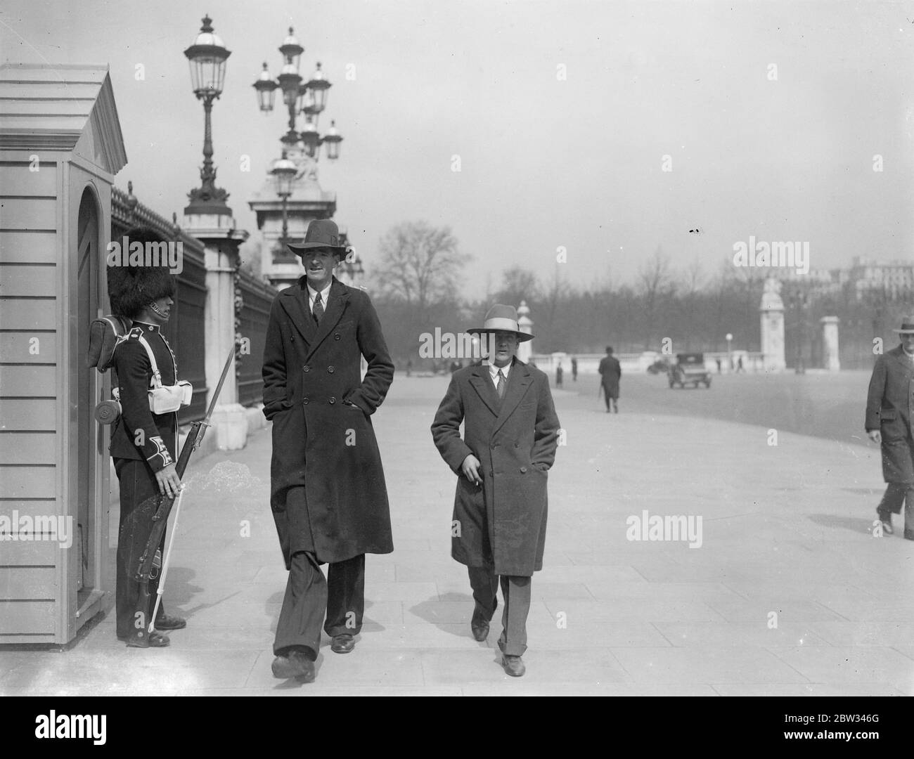 South African giant comes to London in search of work . Dennis Buffey , who is seven feet 11 inches tall , has arrived in London from South Africa , in search of work . Dennis Buffey walking down Whitehall , London with some of his friends . 25 April 1932 . Stock Photo
