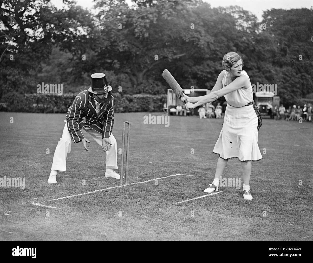 Authors versus actresses at cricket . A team of authors captained by Mr J B Priestly , and a team of actresses captained by Miss Gladys Cooper , met in a cricket match in aid of the North St Pancras Group of the St Pancras Group of the St Pancras House Improvement Society in the beautiful grounds of Mrs Clarence Gasque 's residence at Hampstead , London . Miss Gladys Cooper batting with Mr Ralph Strauss , keeping wicket . 14 July 1932 Stock Photo