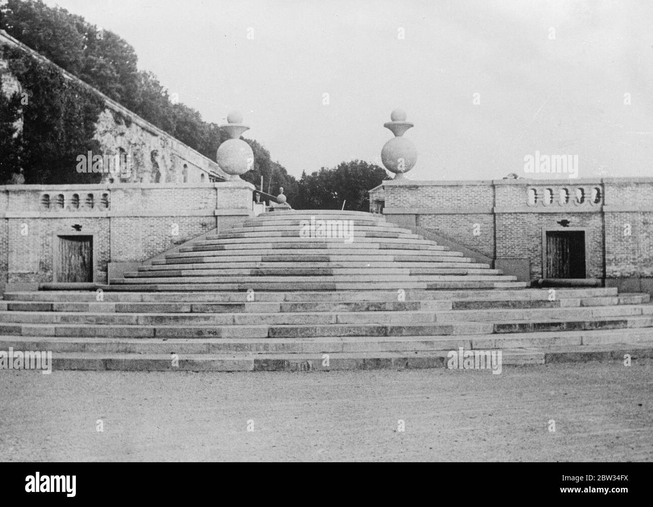 Preparing Pope 's summer villa for coming visit . Preparations are being rapidly rushed ahead for the coming visit of the Pope to his summer villa at Castelgandolfo . The grounds are being beautifully laid out by an army of workmen , and the villa is being renovated and modernised . These pictures were taken by a photographer disguised as a mason , with a camera hidden beneath his clothes , and are the first pictures made of the work . One of the fine approaches to the terraces from which the Holy Father will obtain a fine panorama of the nearby lakes and in the distance he will be able to see Stock Photo