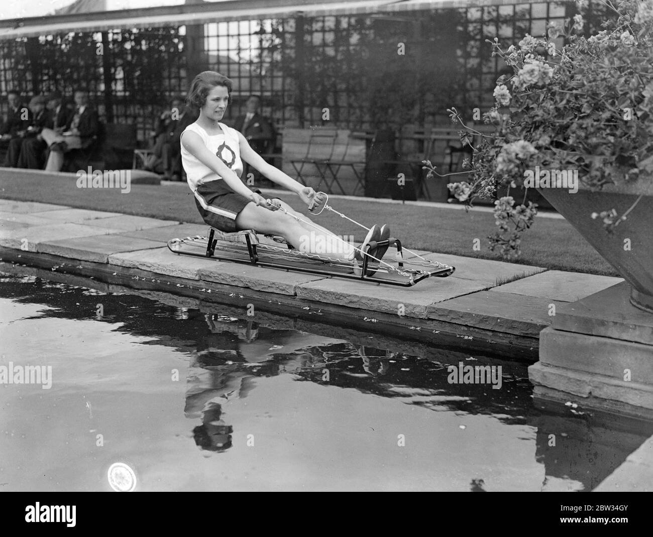 Olympic Games representative practices at lunch time on roof on store . Miss Violet Webb , who has been chosen to represent Great Britain in the hurdles at the Olympic Games at Los Angeles , USA practices every lunch hour on the roof of Selfridges store , where she is employed . Miss Violet Webb in training on a sculling trainer during her roof lunch hour practice . 22 June 1932 Stock Photo