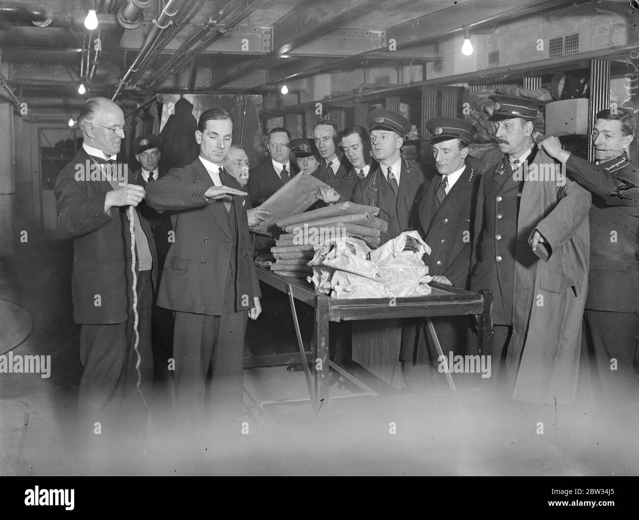 Lighter clothing for London underground employees . The four thousand uniformed employees of the London Underground , are being issued with new and lighter uniforms for the summer . The first of these uniforms were issued at the companys depot at Lambeth . Underground employees being issued with their new Uniforms at Lambeth . 19 April 1932 . Stock Photo