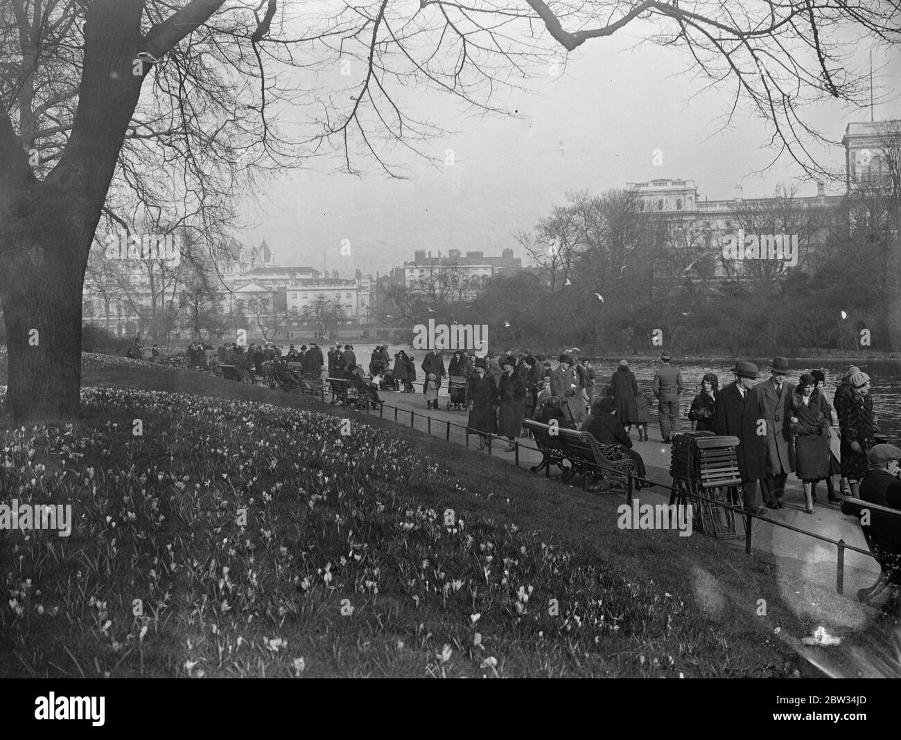 Stay at home Londoners enjoy sunshine in St James Park . Crowds of visitors from the provinces to London , or Londoners who stayed at home for Easter , flocked to St James Park to enjoy the sunshine in the open air . The crowds in St James Park , London , where the crocuses made a riot of colour . 25 March 1932 Stock Photo