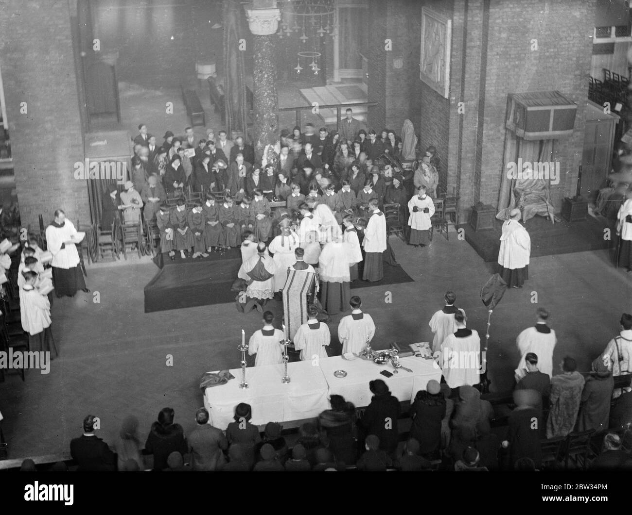 Cardinal bourne carries out Ancient ceremony of washing feet at Westminster . Cardinal Bourne carried out the ancient Maundy Thursday ceremony of the ' Washing of Feet ' when he washed the feet of twelve choirboys in Westminster Cathedral , London . 24 March 1932 Stock Photo