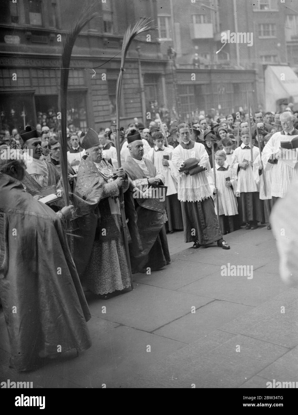 Cardinal Bourne heads Palm Sunday procession at Westminster Cathedral . Cardinal Bourne , head of the Roman Catholic church in England , headed the Palm Sunday procession to Westminster Cathedral , London . Cardinal Bourne blessing the palms at the ceremony outside the Cathedral . 20 March 1932 Stock Photo