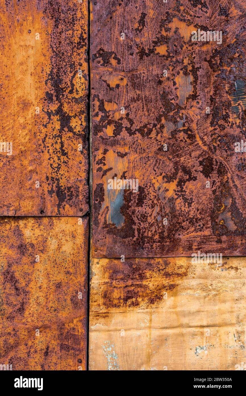 Rusted flat composite nailed metal sheets surface background and texture. Stock Photo