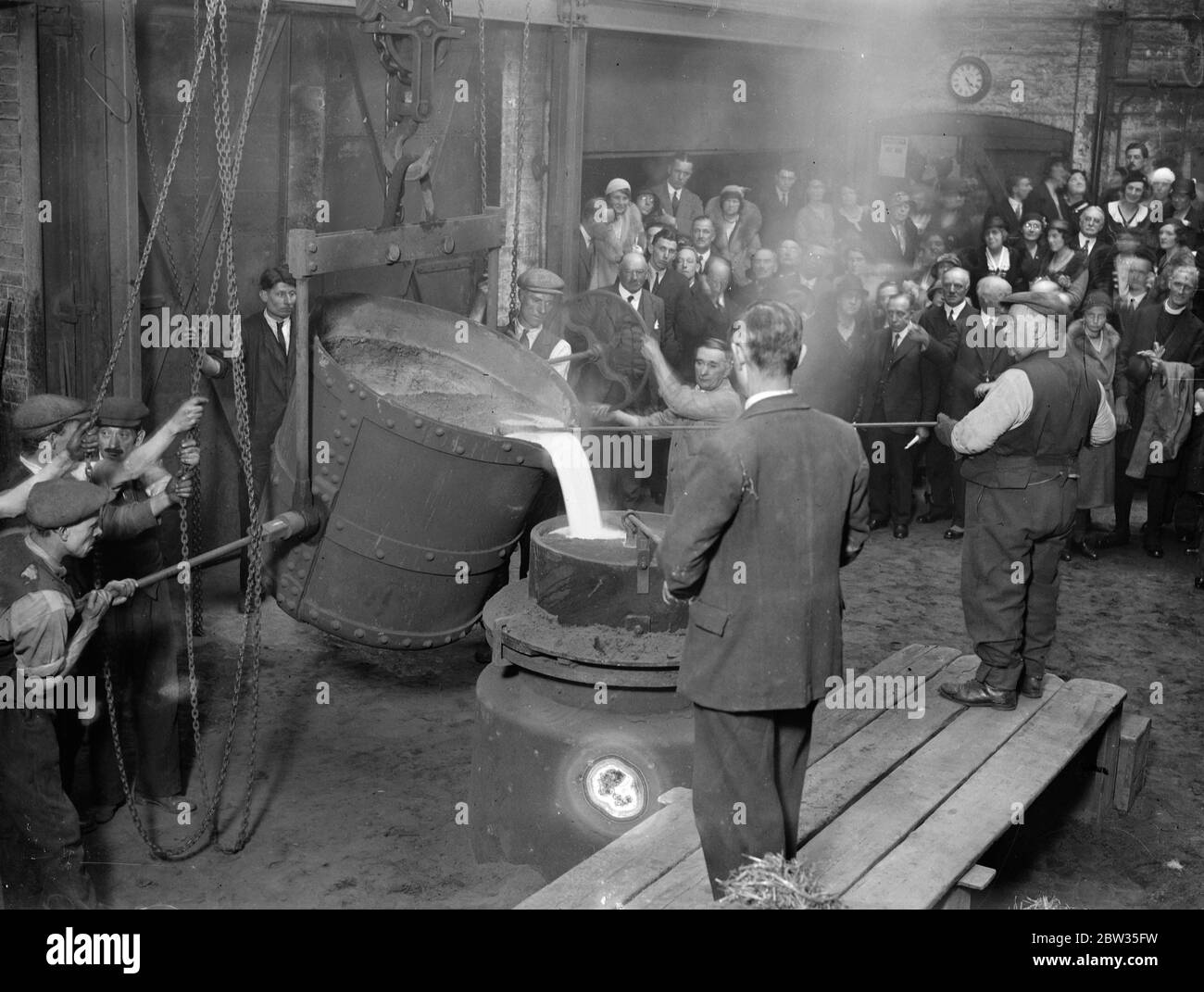 City men see last of the new Bow Bells cast with fitting ceremony at Croydon . The last of the new peal of Bow Bells was cast at the foundry of Gillett and and Johnstone at Croydon when it received the blessing of the City of London and the church . Masters of several city companies were present . The bell was a 2 1/2 tenor .The weight of the whole peal of twelve bells is 10 1/2 tons . For centuries Bow Bells have been a traditional part of the City , but they have not been heard for six years because of the need for their being recast and because of the defective condition of the belfry of St Stock Photo