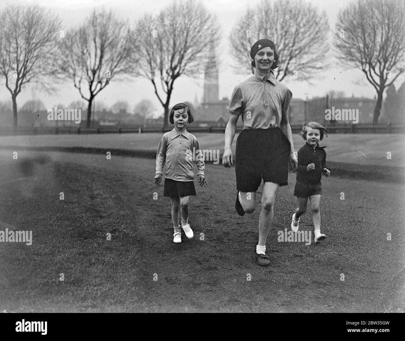 Following in mother ' s footsteps . Mrs Linda Edwards , the well known women athlete , has high hopes that her two daughters Mariane and Paula will earn themselves reputations equal to her own on the track . Mrs Linda Edwards teaching her children Mariane and Paula how to start in a race on the track at Paddington . 27 April 1933 Stock Photo