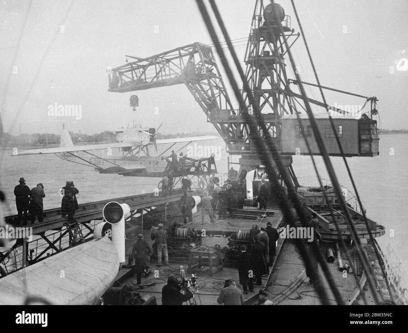 German steamer to be used in trials of a mid Atlantic air base . The German steamer ' Westfalen ' has been reconstructed to serve as a base in the mid Atlantic for the regular air line which the German Lufthansa Company is to establish between Europe and South America . the vessel is equipped with a catapult invented by Herr Heinkel , the aircraft manufacturer , which will be used to enable the machines to take off again . The catapult is said to be the largest in the world . The aircraft are raised on board the base by means of a special drag sail and crane . A hydroplane on the mid Atlantic Stock Photo