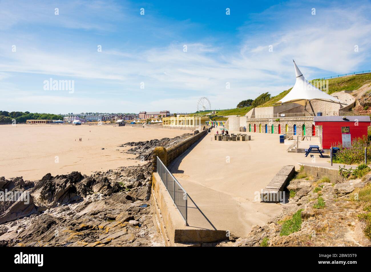 The promenade and sandy beach at Barry Island are very quiet on a sunny Spring bank holiday afternoon during the 2020 coronavirus crises. Stock Photo