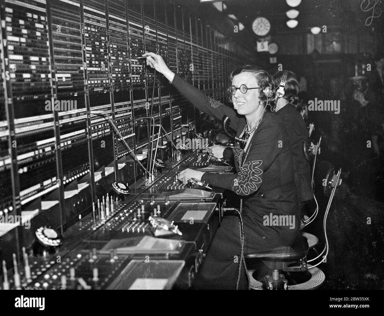 The Princeof Wales talks in Spanish with telephone operator . When the Prince of Wales inspected the great new world telephone centre at the Faraday building in London he conversed in Spanish with one of the switchboard operators , all of whom are expert linguists . The operator was Miss Marion Hart .The Prince was passing her switchboard when he heard her speaking in Spanish . When she had dealt with the call he chatted with her in the same language , with which he has become familiar during his South American travels . Photo shows ; Miss Marion Hart at the Buenos Aires switchboard today . Sh Stock Photo