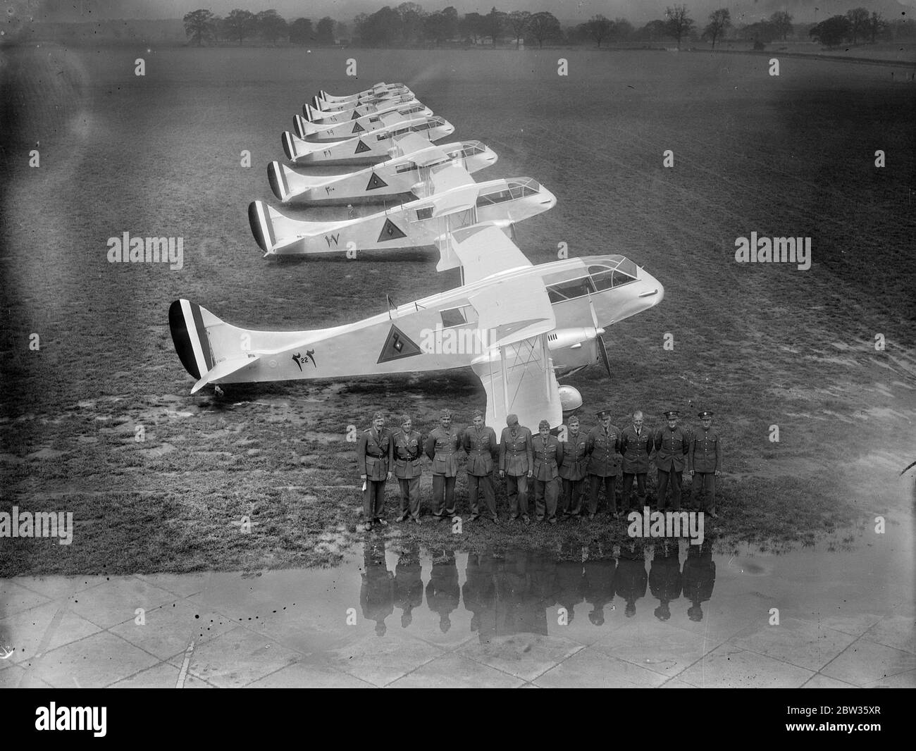 Eight de Haviland  Dragon  planes with five Iraqi pilots leave Hatfield to join Iraqi Air Force . Eight de Havilland  Dragon  aeroplanes , adapted for military use and capable of carrying ten passengers , left Hatfield Aerodrome , Hertfordshire , to join the Iraqi Air Force and assist in maintaining order around the Iraq border . Photo shows ; A view of the eight planes and their crews lined up before the start of the flight at Hatfield . 5 May 1933 Stock Photo