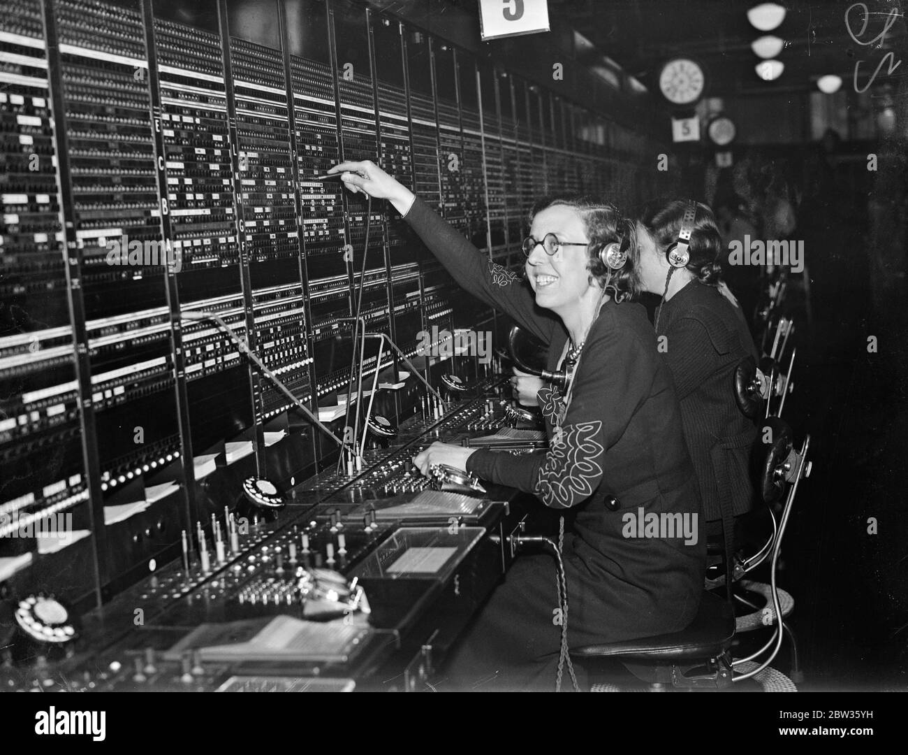 The Princeof Wales talks in Spanish with telephone operator . When the Prince of Wales inspected the great new world telephone centre at the Faraday building in London he conversed in Spanish with one of the switchboard operators , all of whom are expert linguists . The operator was Miss Marion Hart .The Prince was passing her switchboard when he heard her speaking in Spanish . When she had dealt with the call he chatted with her in the same language , with which he has become familiar during his South American travels . Photo shows ; Miss Marion Hart at the Buenos Aires switchboard today . Sh Stock Photo