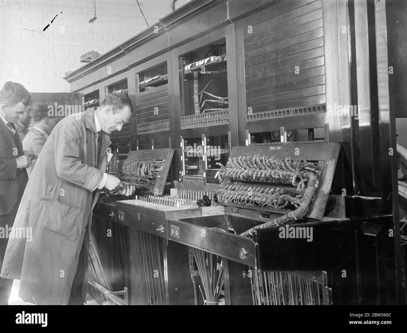 Where World Economic Conference will meet . The new building of the Geological Museum in Kensington , London has been chosen as the meeting place for the World Economic Conference at which delegates from sixty six nations will endeavour to solve the world ' s difficulties in June . Photo shows ; Engineers setting up communications for the conference . 15 May 1933 Stock Photo