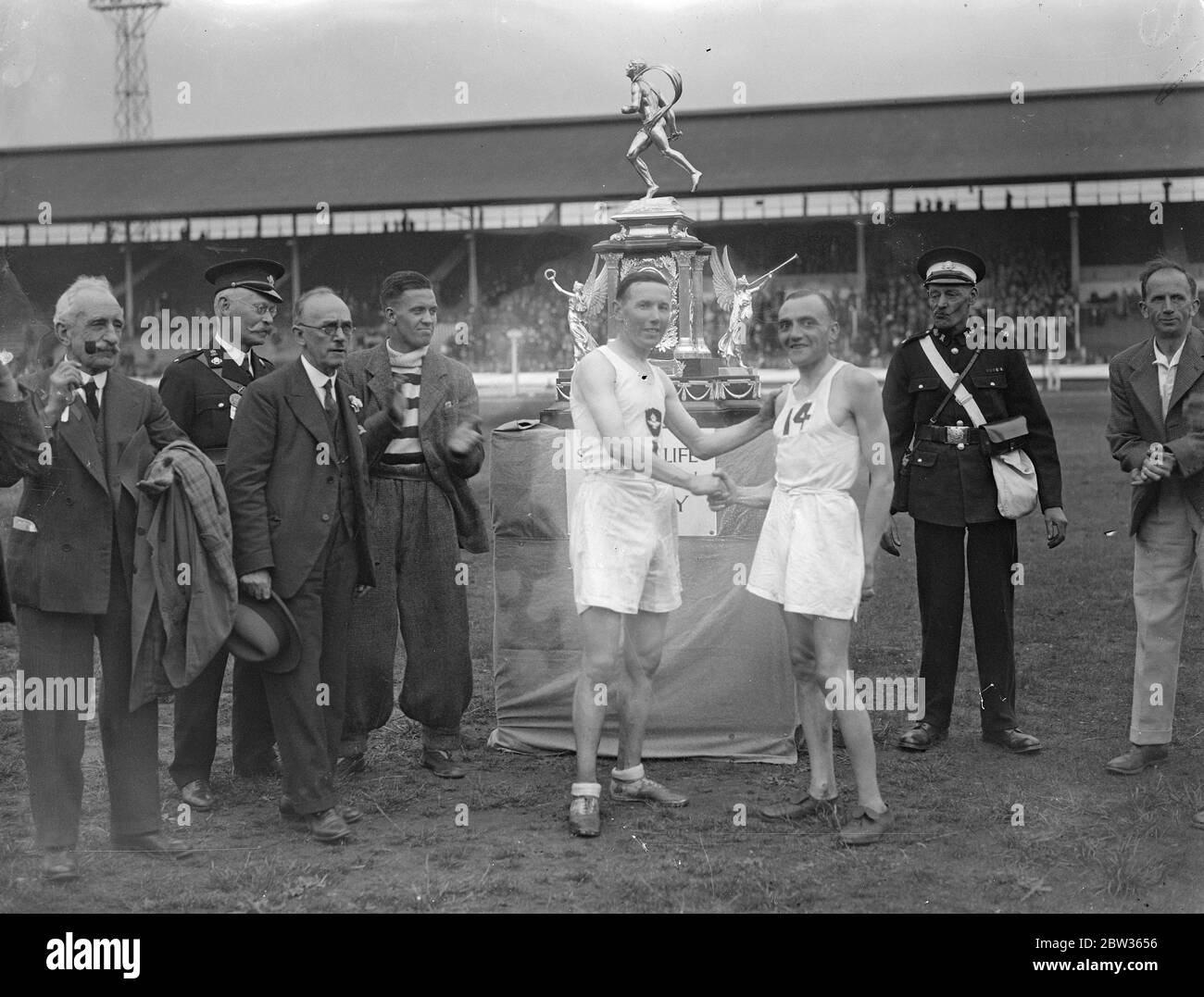Sam Ferris wins Kinnaird Trophy Marathon race for eighth time . Sam Ferris , the Royal Air Force runner , won the Great Marathon race from Windsor to the White City , London , a distance of twenty six miles for the eighth time . Sam Ferris ( left ) winner of the Kinnaird Trophy shakes hands with the runner - up . 10 June 1933 Stock Photo