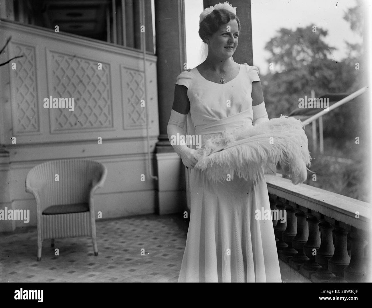 Betty Nuthall presented at Court . Betty Nuthall , the tennis player who is to take part in the Wimbledon Championships next week , was presented at the last Court of the Season at Buckigham Palace by Lady Crosfield , Photo shows : Miss Betty Nuthall in her Court gown . 23 June 1933 Stock Photo