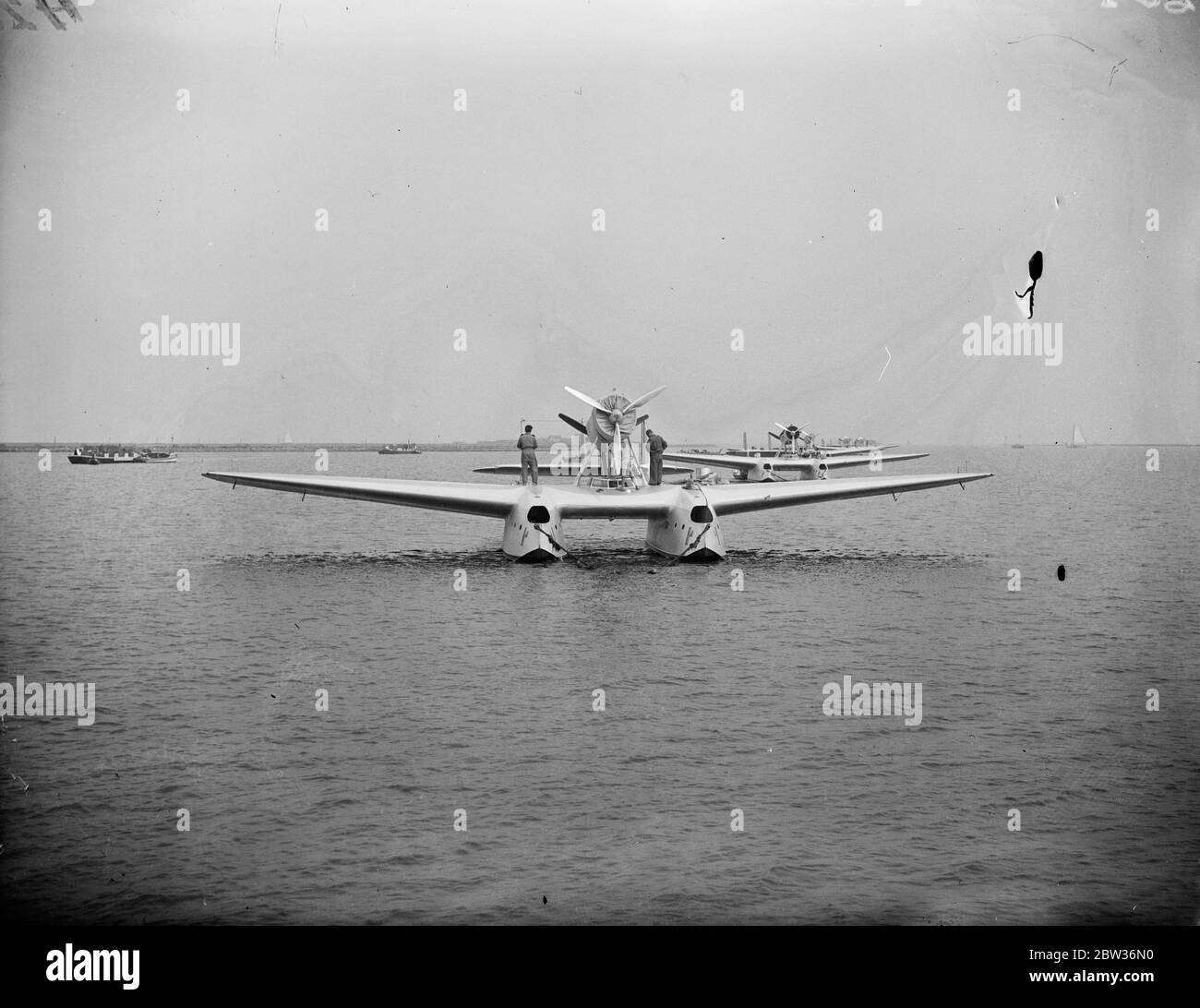 One killed four injured on first stage of great formation flight to United States . A tragedy marred the first stage of the flight of the Italian air armada of 24 Savoia - Marchetti SM.55X flying boats led by General Balbo , the Italian Air Minister , to America . On arrival at Amsterdam from Ortobello , near Rome , one of the machines capsized killing one airman and injuring four others . The other 23 machines will continue the flight , the greatest formation flight ever attempted . Photo shows ; planes of the the Italian air armada lined up on the water at Amsterdam . 1 July 1933 Stock Photo