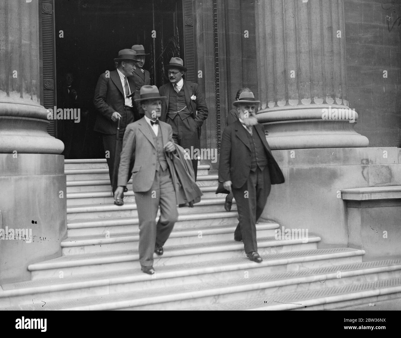 Representatives of 31 wheat importing and exporting countries met at Canada House , London , to try and reach an agreement on the production of and trade in wheat . The conference is continuing on a larger scale conversations which began at Geneva . The exporting countries are asking for the co operation of the importing countries in the form of an agreement to lower tariffs against wheat and remove other restrictions on the free flow of trade as prices rise . Photo shows ; Delegates leaving after the opening session . Dr Laur of Switzerland is the man with the beard . 31 August 1933 Stock Photo