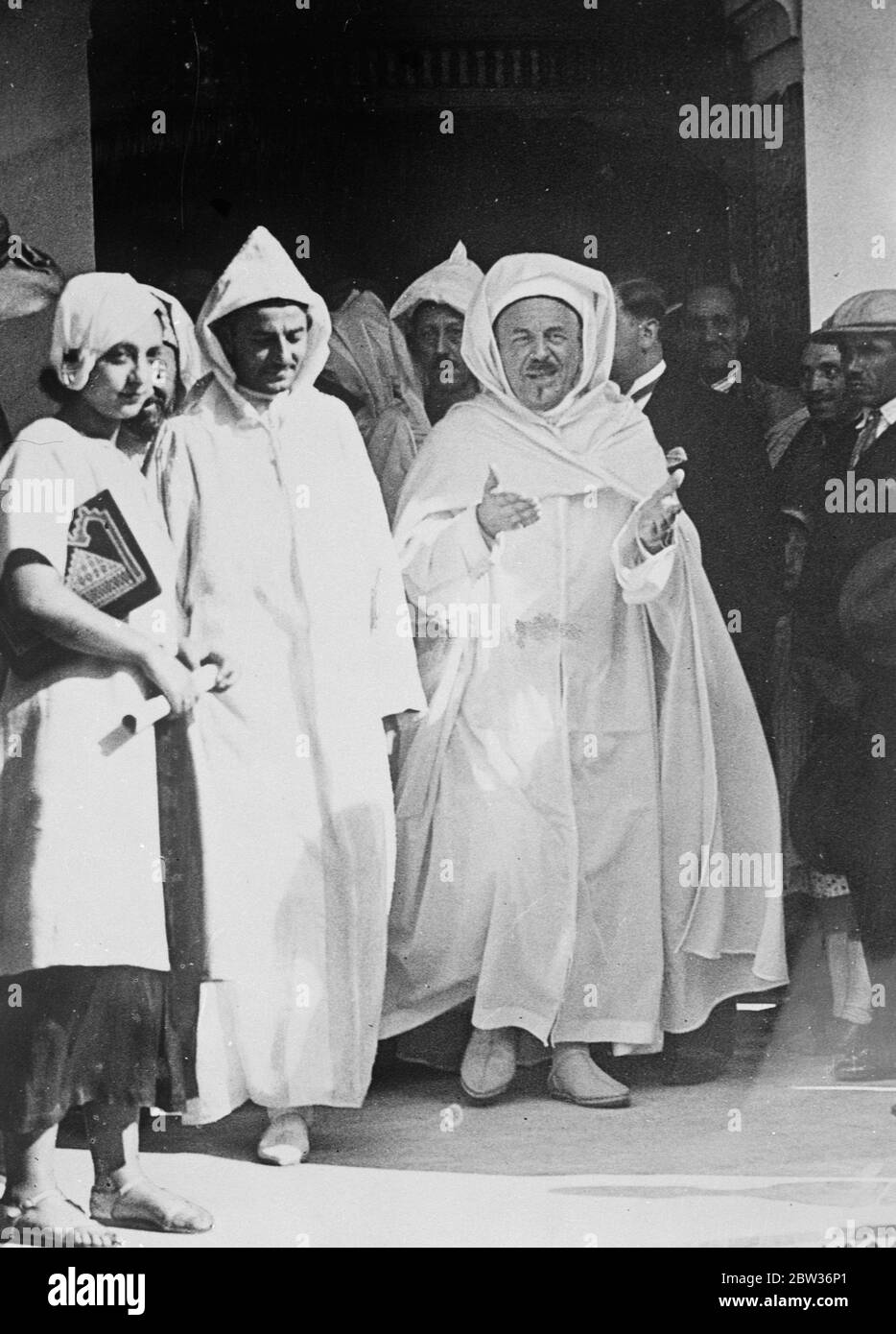 Sultan of Morocco visits Paris Mosque . The Sultan of Morocco , who is on his annual visit to the French capital , attended the Paris Mosque where he was received by Si Kaddour ben Ghabrit , head of the Moslem community in Paris . Photo shows ; The Sultan of Morocco ( left ) leaving the Paris Mosque with Si Kaddour ben Ghabrit . 22 August 1933 Stock Photo