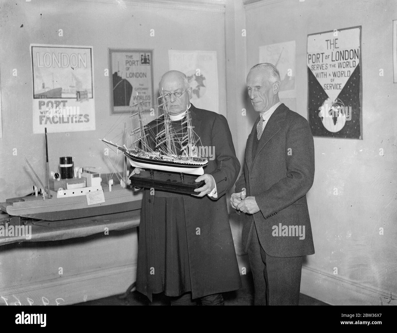 Dean of Westminster opens Port of London Authority art exhibition . The Dean of Westminster , Dr Foxley Norris who is himself a well - known artist , opened the annual Port of Lord Authority art exhibition at the Authority ' s headquarters in Trinity Square . Photo shows ; The Dean of Westminster inspecting a model ship with Lord Ritchie , Chairman of the Port of London Authority after opening the exhibition . 29 November 1933 Stock Photo