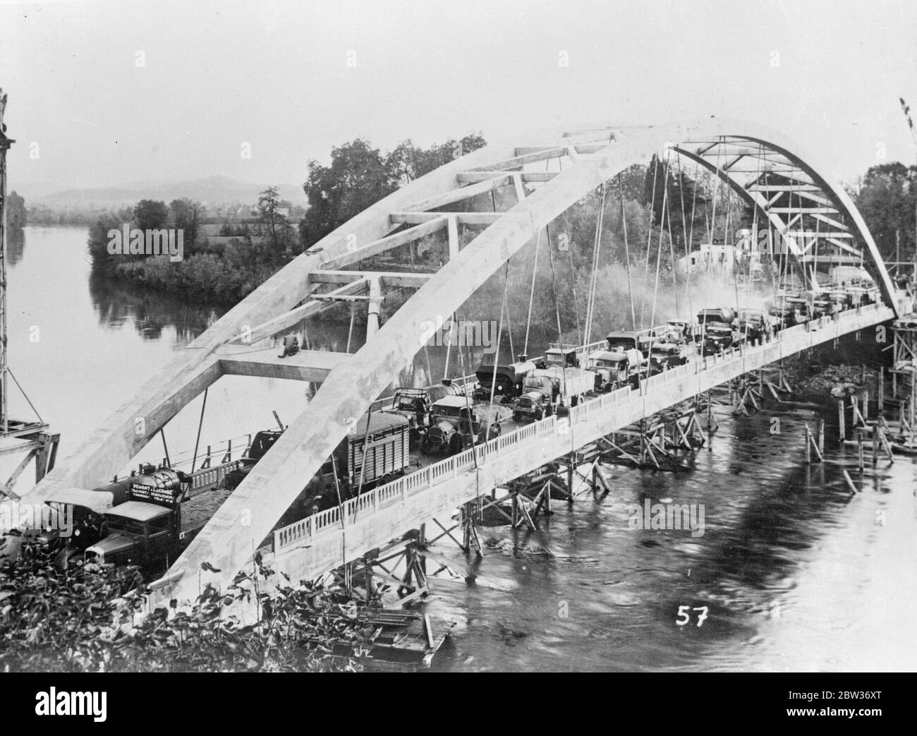 Bridge claimed to have world ' s biggest span completed in France . A new bridge , claimed to have the largest single span in the world , has just been completed across the River Lot in France . It links Villeneuve and Castelmoron . The span is more than 146 metres in length . The bridge was tested for safety with 400 tons dead weight and 250 tons of traffic . Photo shows ; The traffic crossing the new bridge during the test . 29 November 1933 Stock Photo