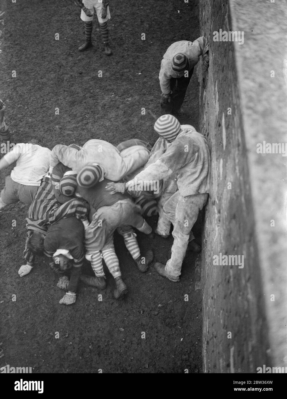 The St Andrew ' s day wall game takes place at Eton . The annual St Andrew ' s day Eton wall games between the Collegers and the Oppidans took place in the grounds of Eton College Windsor . The game was the ninety second . Photo shows ; A view of the wall game scrums from the top of the wall . 30 November 1933 Stock Photo
