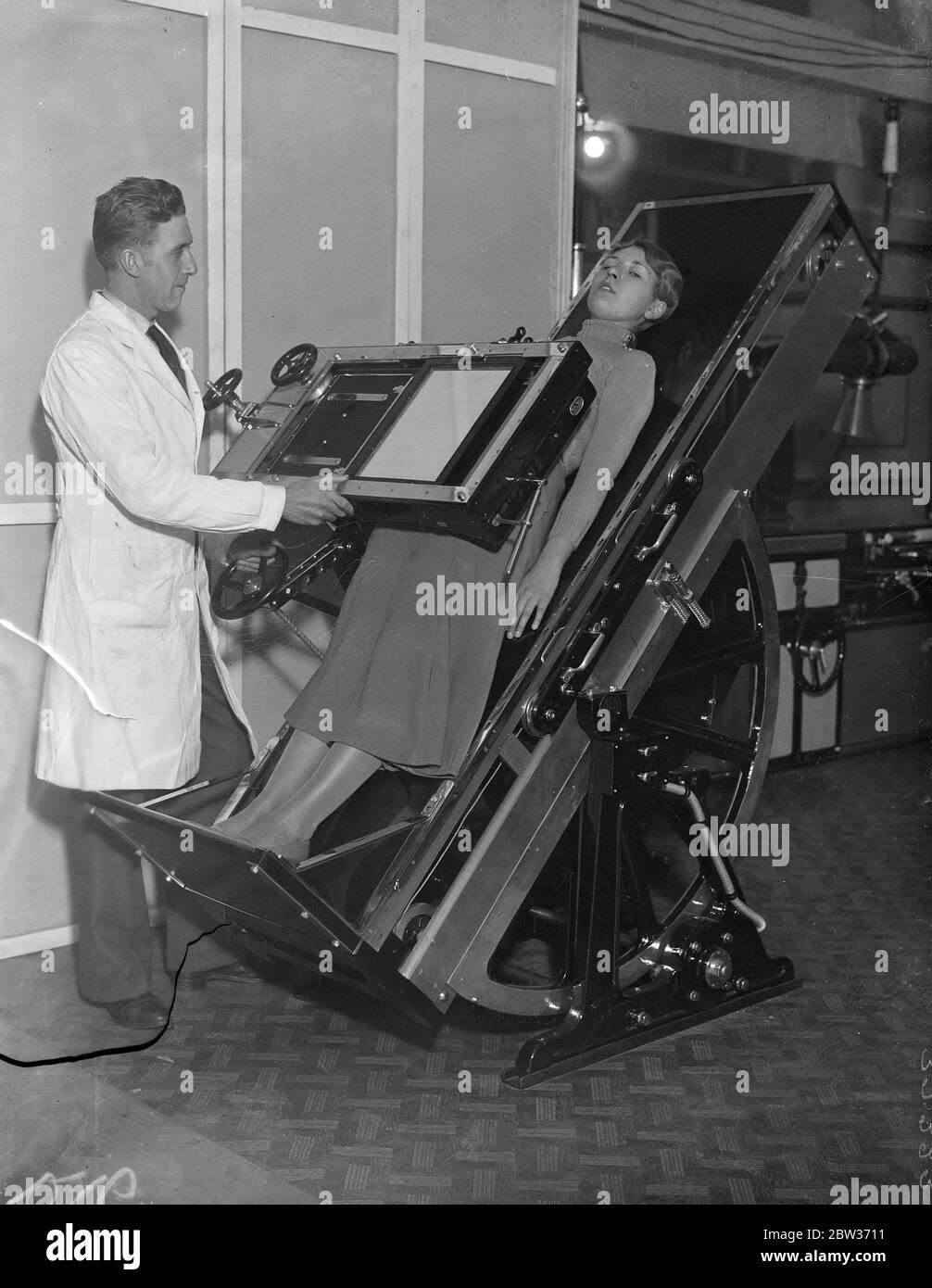 Radio logistics hold annual exhibition . The British Institute of Radiology held its annual congress and exhibition at the Central Hall ,Westminster . Photo shows ; The latest photographic couch for X ray work being demonstrated . 6 December 1933 Stock Photo