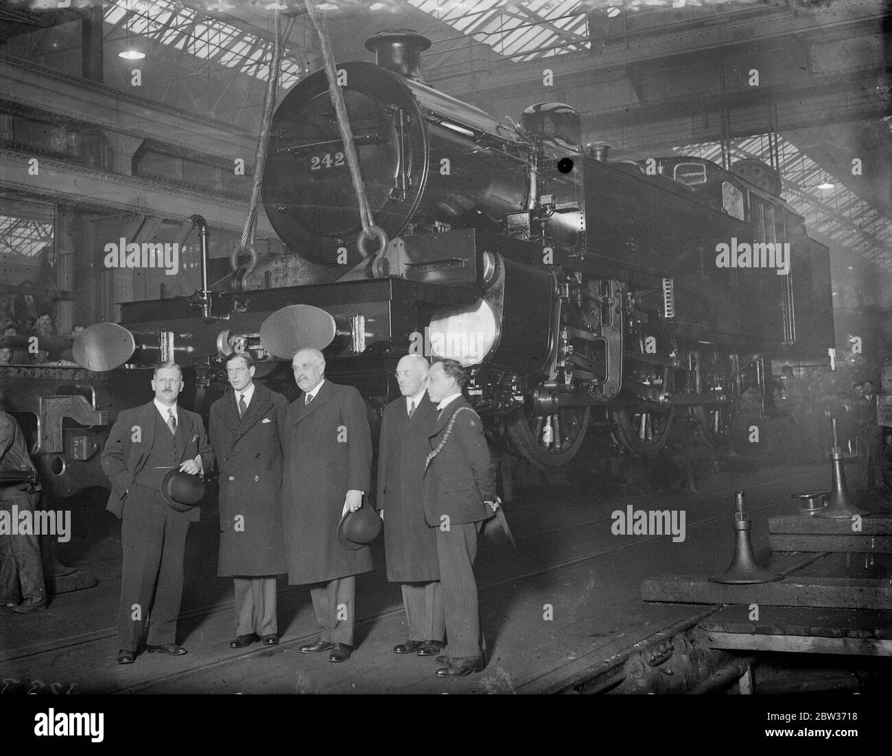 Prince George visits London Midland and Scottish Railway works at Derby . Photo shows ; Prince George with Sir Josiah Stamp , President of the LMS and the Mayor of Derby , during his visit to the works . 6 December 1933 Stock Photo