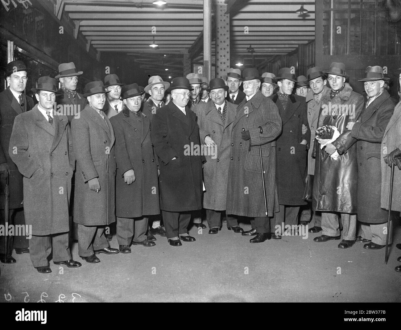 Austrian football team arrive in London . The Austrian football team from Vienna , who are to play the Arsenal , and Scotland , arrived at Victoria Station , London . They are leaving for Scotland tonight . Sir Frederick Wall , of the Football Association , and Mr Percy Chapman received the team . Photo shows ; The Austrian Football Team with Sir Frederick Wall and Mr Percy Chapman , on arrival at Victoria . 26 November 1933 Stock Photo