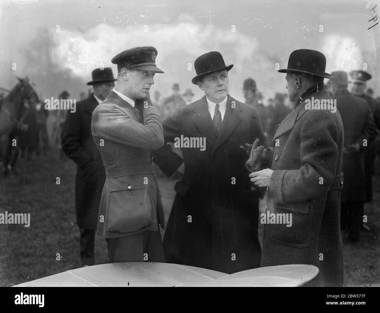 RAF plane down in Hyde Park . A Royal Air Force aeroplane landed in Hyde Park , London , after narrowly missing Marble Arch and trees that were in the path of the plane . The machine was being piloted by Pilot Officer Smith . Photo shows ; Pilot Officer Smith talking to officials . 11 December 1933 Stock Photo