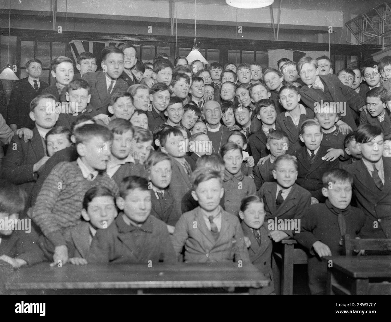 Bishop of London among schoolboys . The bIshop of London opened the new Hall of the St George the Martyr Schools , in Old Gloucester Road , London . Photo shows , the Bishop of London among the schoolboys after opening the new hall . 27 January 1932 Stock Photo