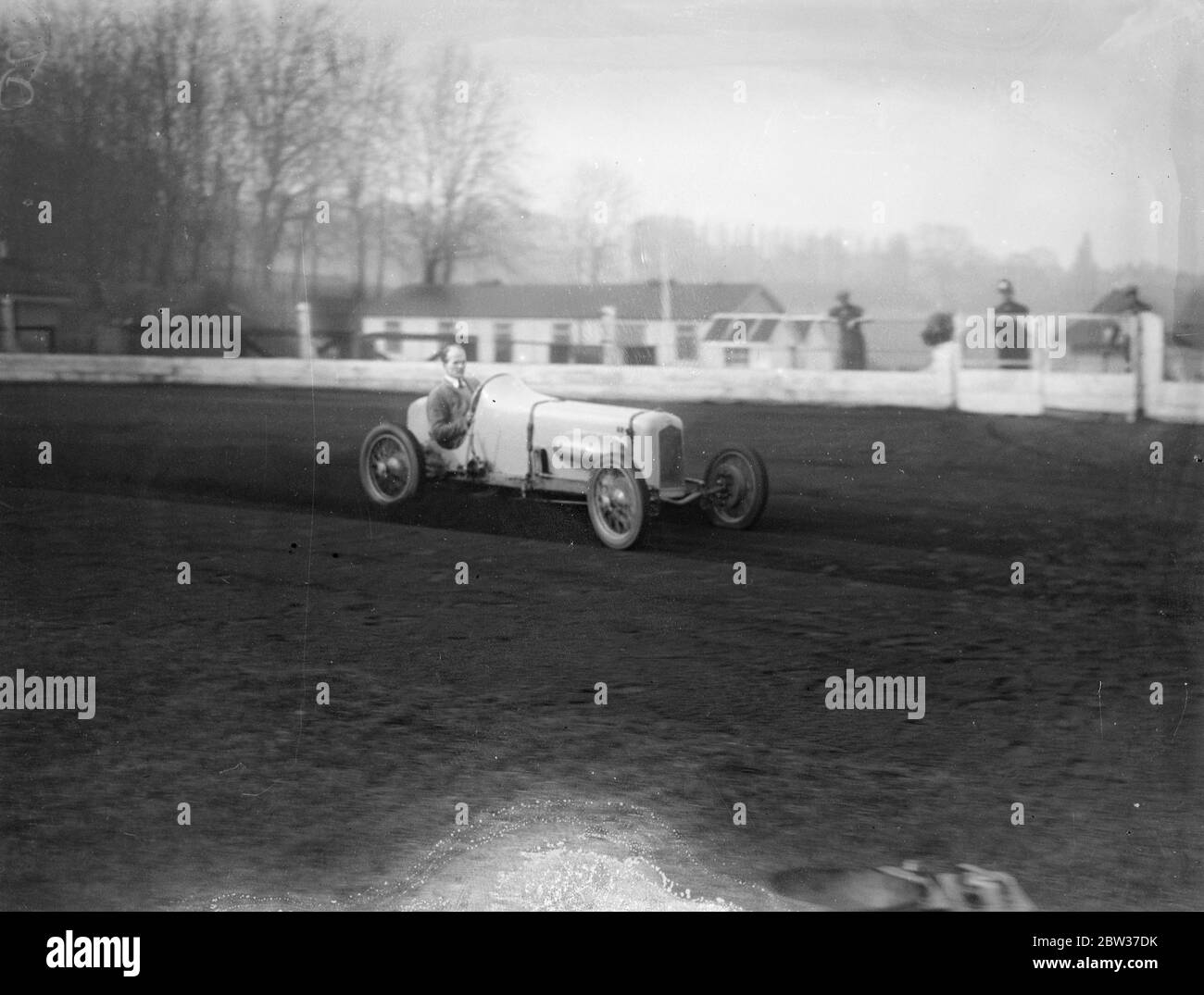 Famous drivers to set up new record for 1500 cc cars at Crystal Palace on Saturday . Mr R G J Nash , the famous hill climbing exponent , in a special super charged Anzani Nash car , is to establish a new land record for cars of the 1500 cc class , on the Crystal Palace speedway track , on Saturday . At preset their is no lap record for cars of this class . Photos show , Mr R G J Nash in his super charged Anzani Nash car , at speed during practice for the record at the Crystal Palace . 27 March 1934 Stock Photo