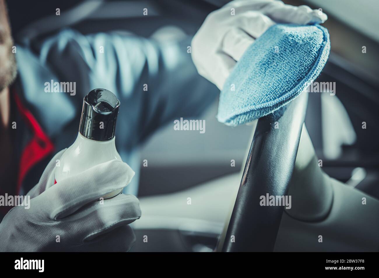 Caucasian Men Taking Care of Car Interior. Cleaning Steering Wheel