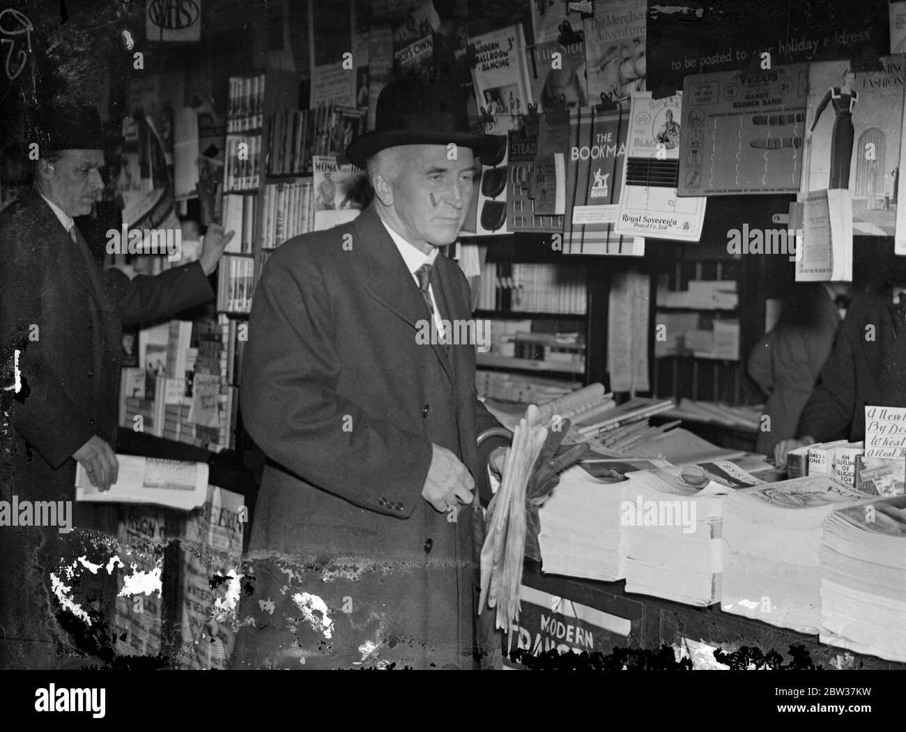 Sir John Simon leaves for Geneva . Sir John Simon , the Forign Secretary , left London for Geneva to attend the Disarmament Conference . Phot shows Sir John Simon buying a paper at the bookstall on Victoria station before his departure from London . 17 January 1934 Stock Photo
