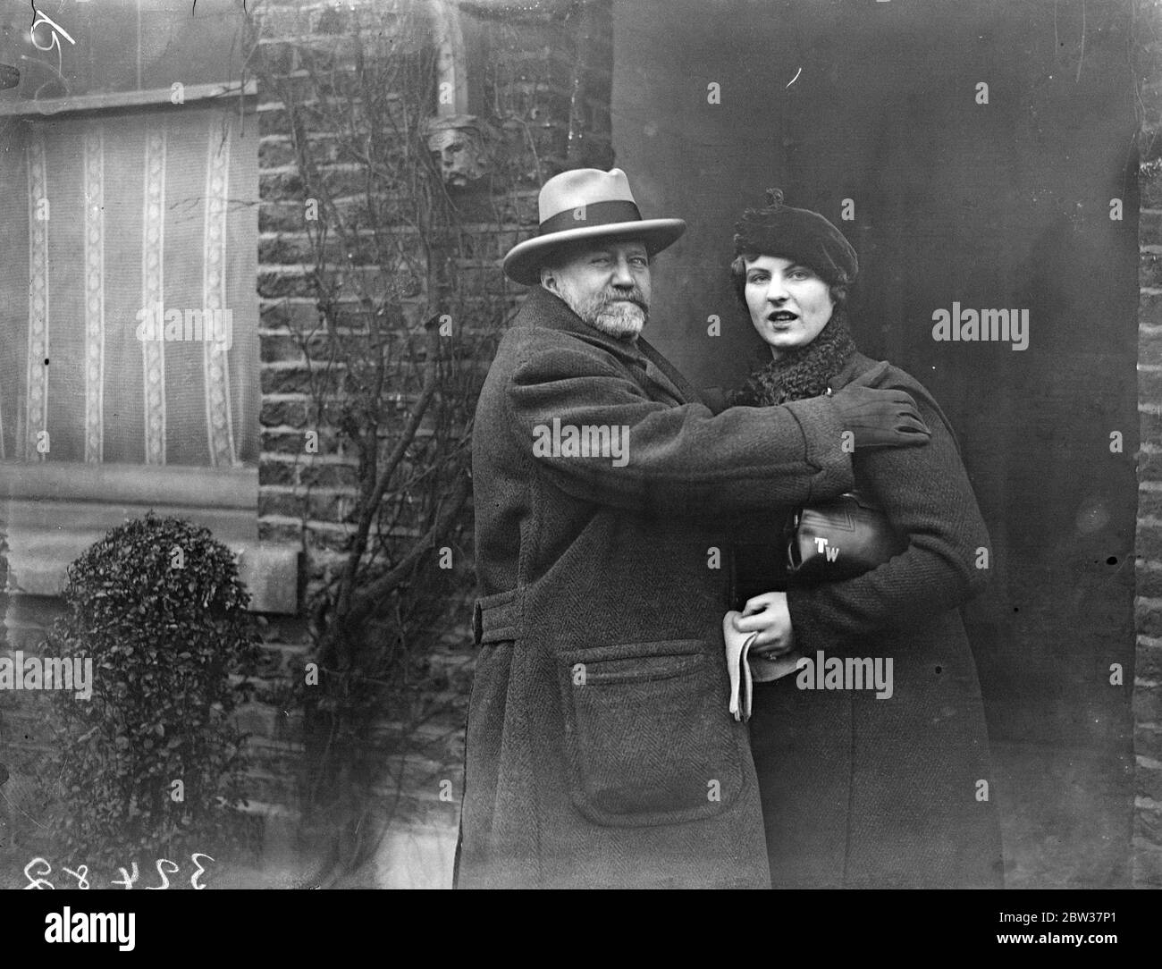 Sir Henry Wood off to Bermuda . Will conduct in America . Sir Henry and Lady Wood left Euston Station , London , for Bermuda . From there they will cross to America where Sir Henry will conduct three concerts at Boston . Photo shows ; Sir Henry Wood embracing his daughter , Tatiana , on leaving his London home . 21 December 1933 Stock Photo