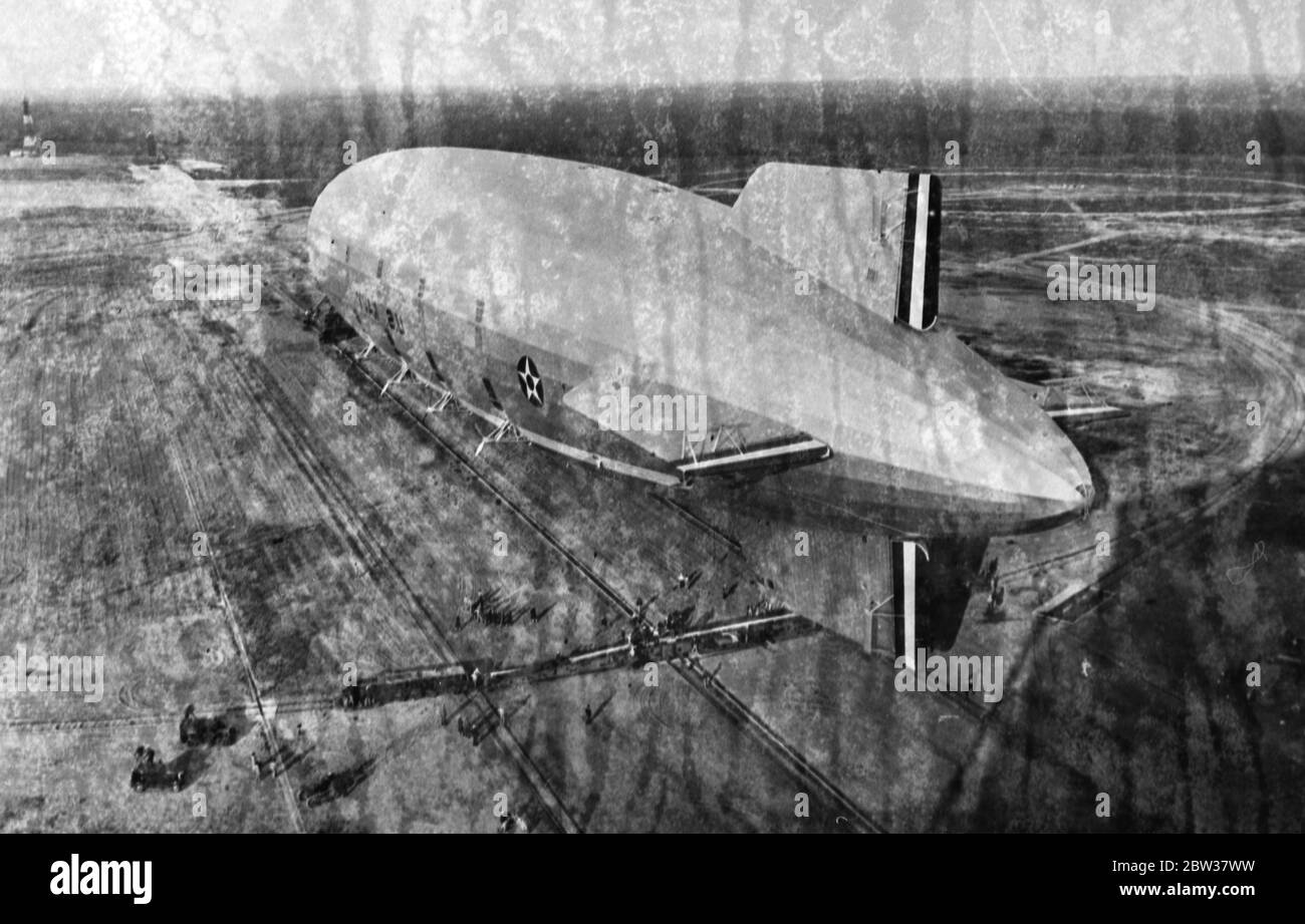 Worlds largest airship is berthed . USS Macon (ZRS-5) , the largest airship of the American Navy and among the largest flying objects in the world in terms of length and volume , was berthed in Lakehurst , Jersey , after flying from Akron . The giant airship , sister to the ill fated USS Akron (ZRS-4) , will be in Lakehurst until September , where she will be taken to Sunnyvale , California . 30 June 1933 Stock Photo