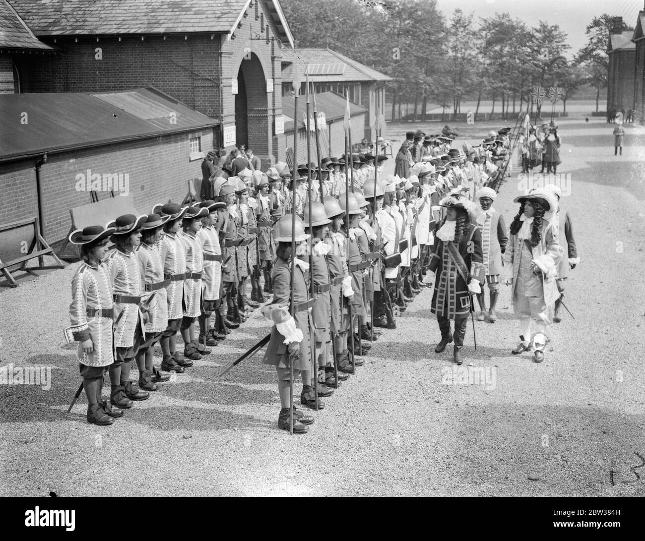 Historical uniforms issued to troops for Aldershot tattoo . Historical uniforms and costumes embracing representations from the reign of James II to full dress uniforms worn by the Indian Army of the present day were issued at Albuhera Drill Hall , Aldershot , to troops taking part in this year ' s Aldershot Tattoo . An inspection was held afterwards . Photo shows , James II ( right ) and William III inspecting the Tattoo uniforms . 12 May 1934 Stock Photo