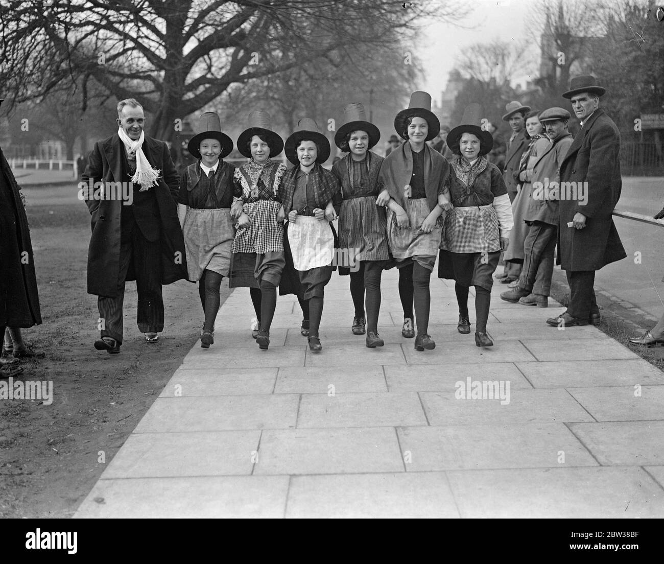 Welsh children ' s choir at Ealing in National Costume . Child members of the Aberaman juvenile choir of Wales practiced on Ealing Green before giving a concert at Ealing Town Hall . The choir has won over 300 prizes , including 11 national awards . Photo shows , some of the children in their national dress . 11 April 1934 Stock Photo