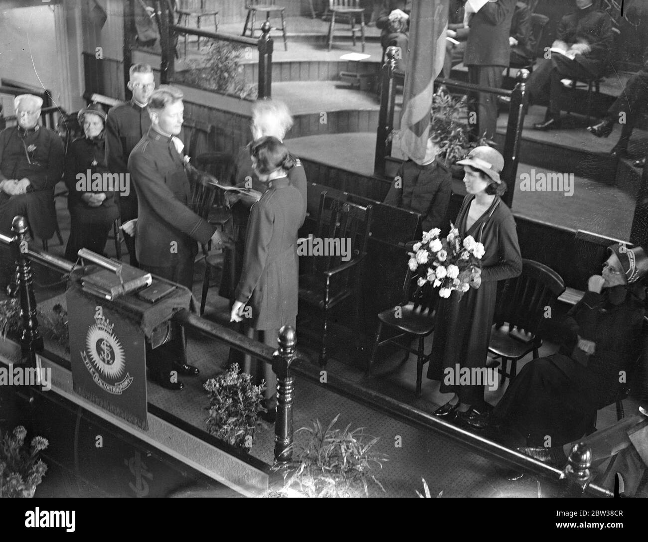 Captain Sture Larsson , commanding officer of the Streatham Vale Corps of the Salvation Army , was married at Penge Citadel to Captian Flora Benwell of International headquarters . Photo shows the ceremony in progress . 11 September 1934 Stock Photo